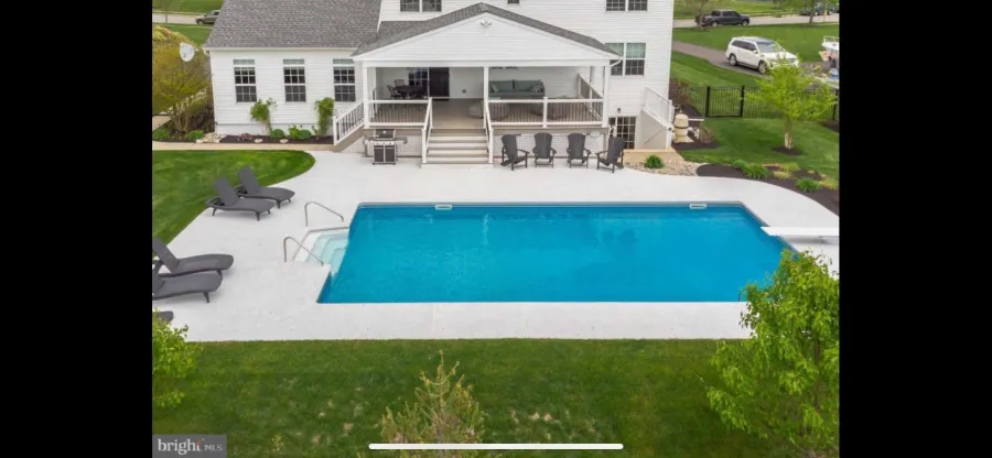 new composite deck tan decking white lattice covered porch concrete pool deck