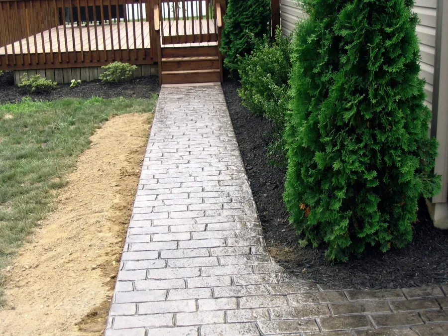 new deck with stamped concrete walkway