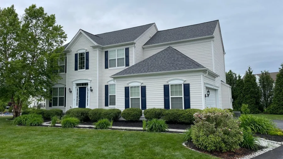 new roof replacement white house blue shutters