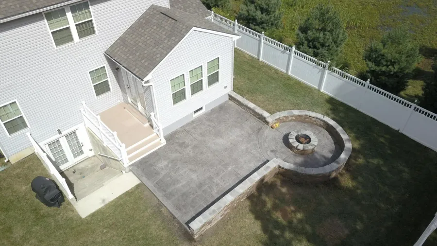 new small composite deck large stamped concrete patio fire pit1