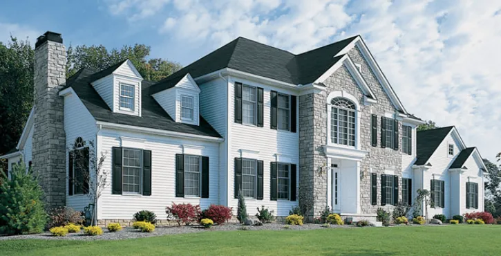 roof replacement white house stonework black shutters