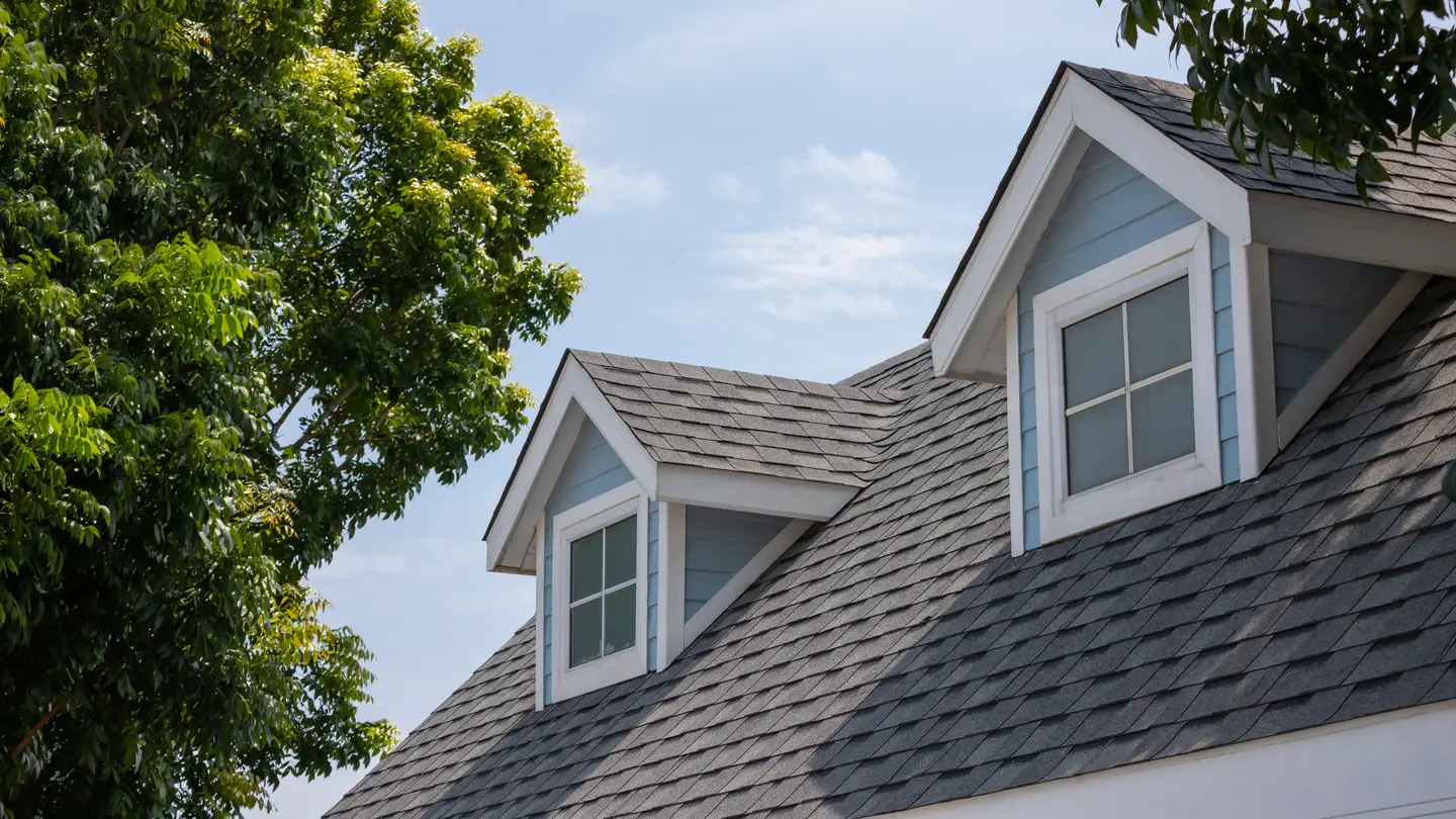 Gray shingles on a roof with two windows in Sicklerville, NJ, by Ameritech Services