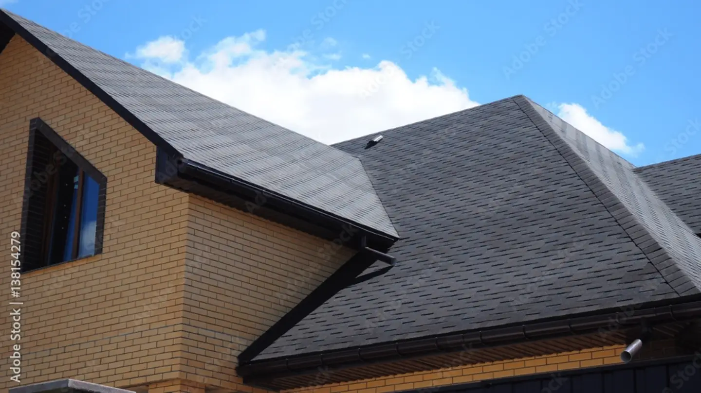 A Washington Township NJ modern brick house with dark gray asphalt shingles installed by Ameritech Services professionals