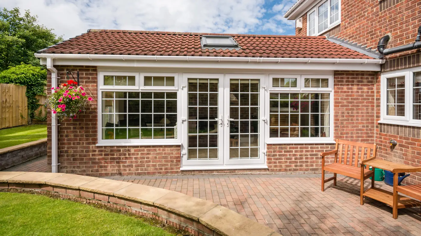 White patio doors on the back of a red brick home in Blackwood, NJ, by Ameritech Services