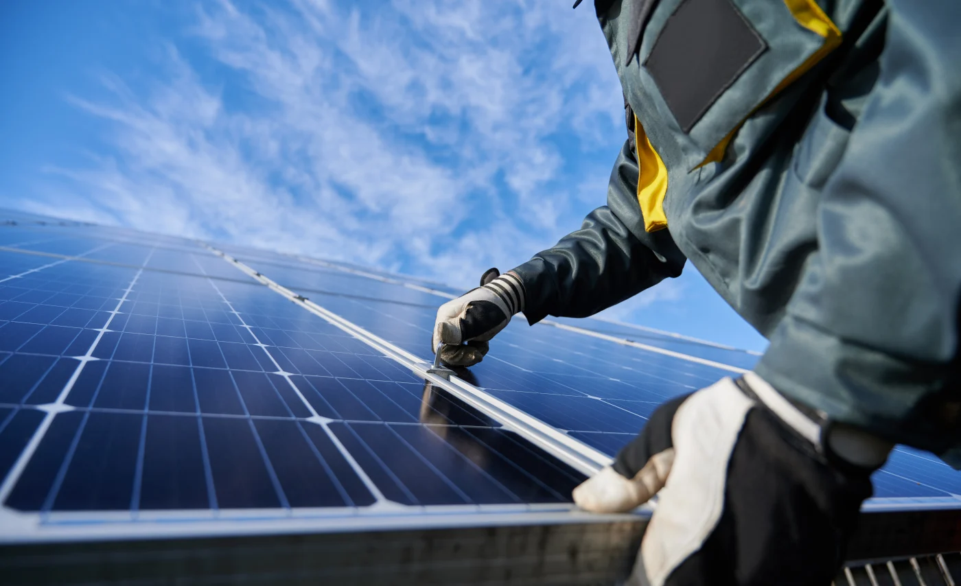 Close-up of an Ameritech NJ roofer installing solar panels.