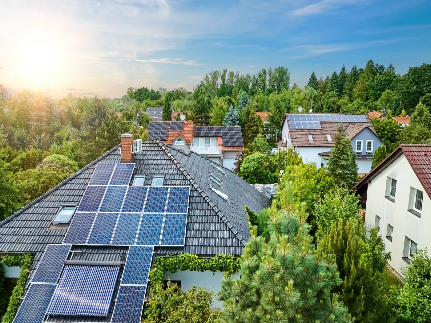 Aerial view of the roofs of houses covered with solar panels and photovoltaic panels installed by Ameritech Services in South Jersey for home electricity generation and green living.