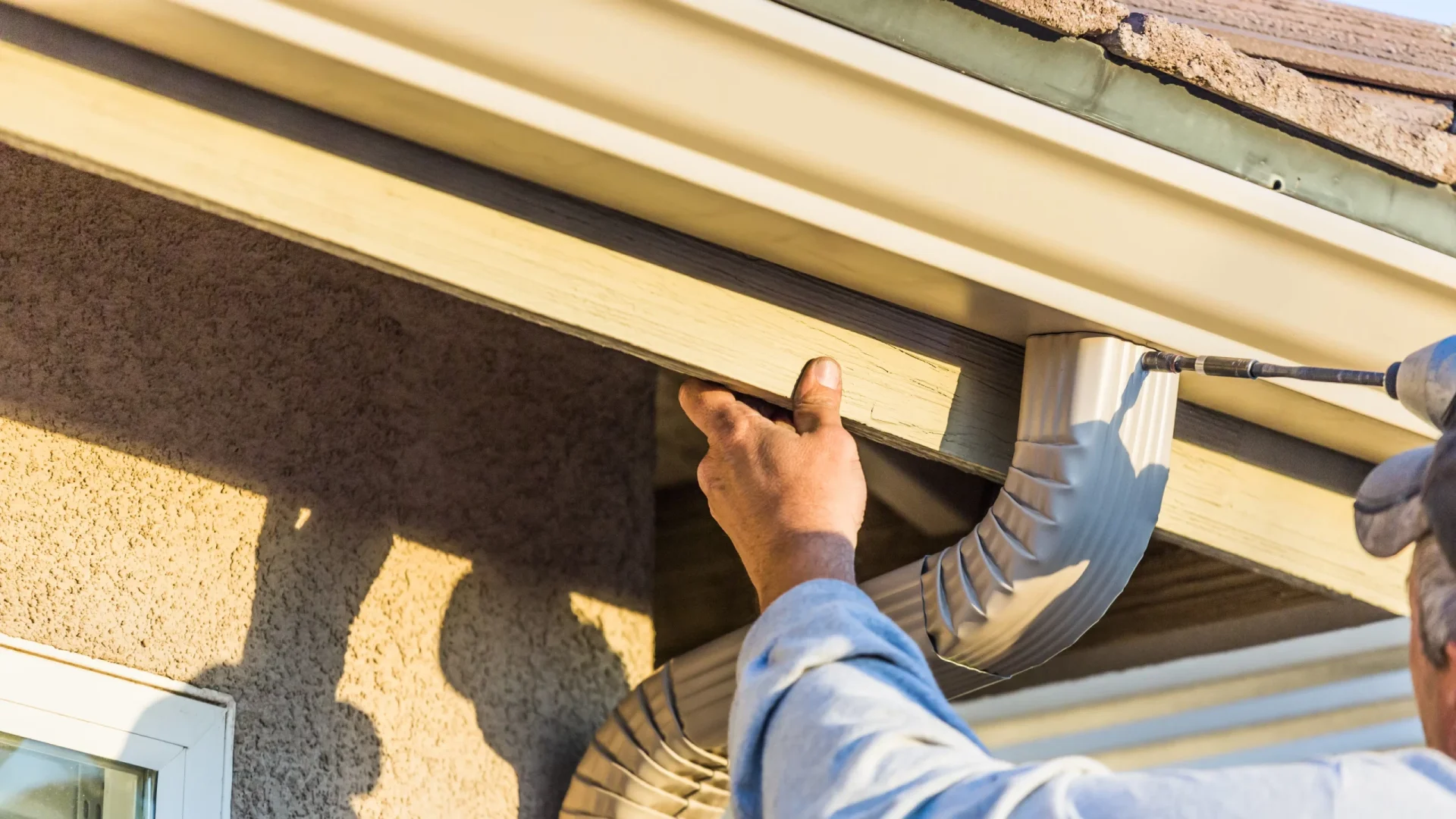 A drainpipe being installed on a gutter system in Marlton, NJ, by Ameritech Services.