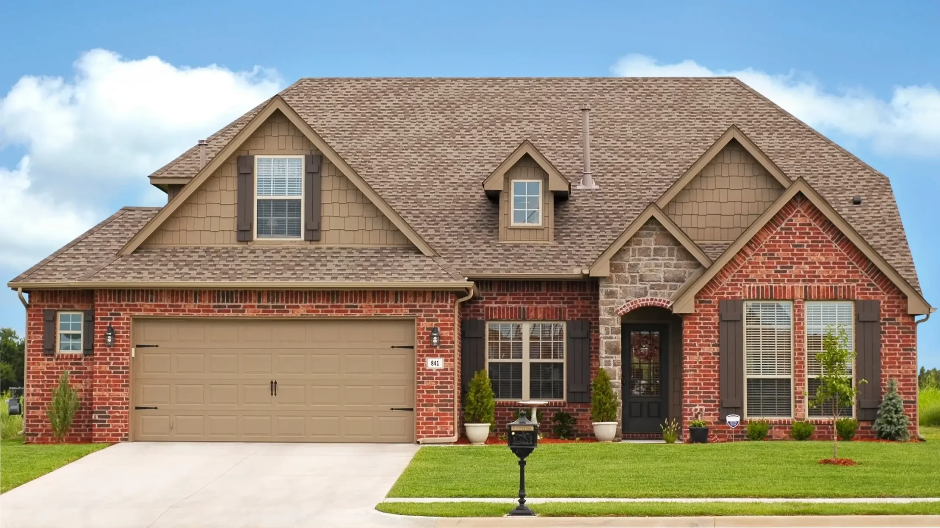A red brick house with a brown roof in Marlton, NJ, by Ameritech Services