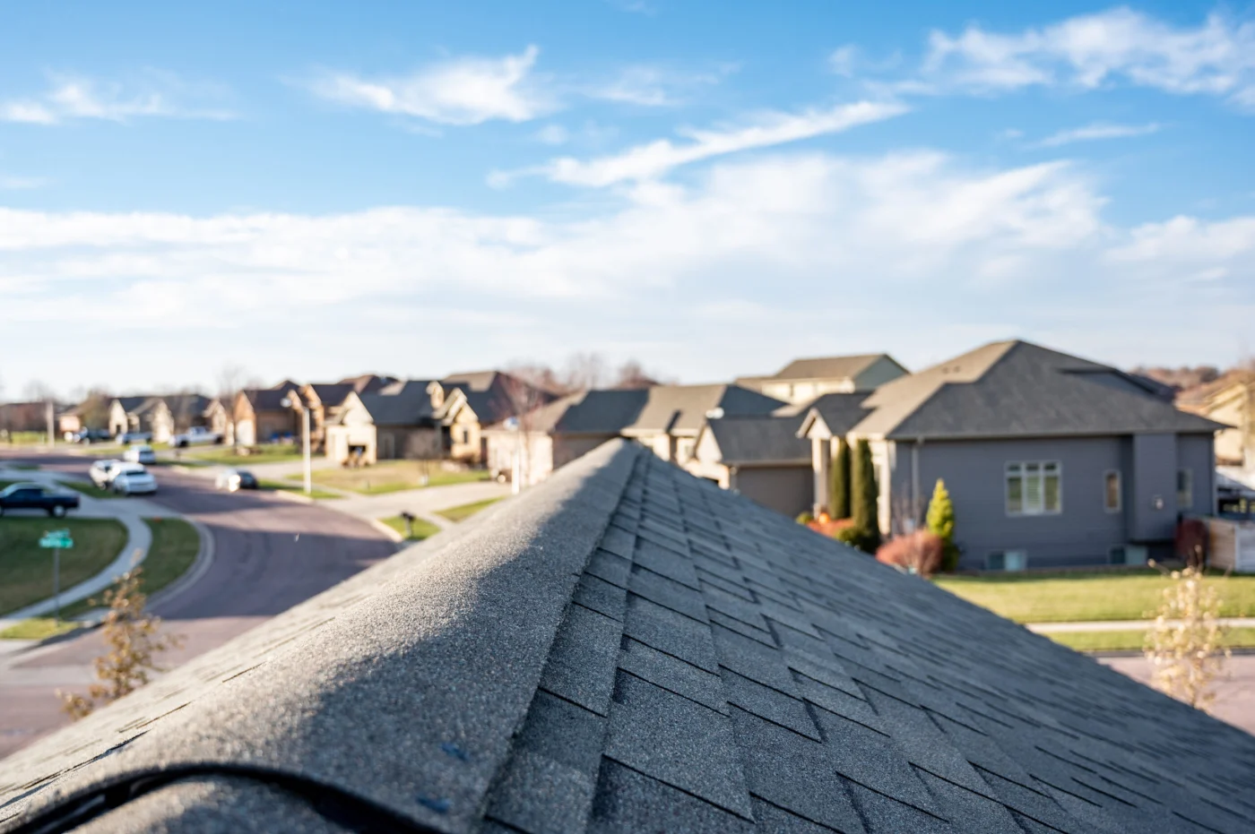 A photo taken from the top of a home with a recently replaced roof overlooking a neighborhood
