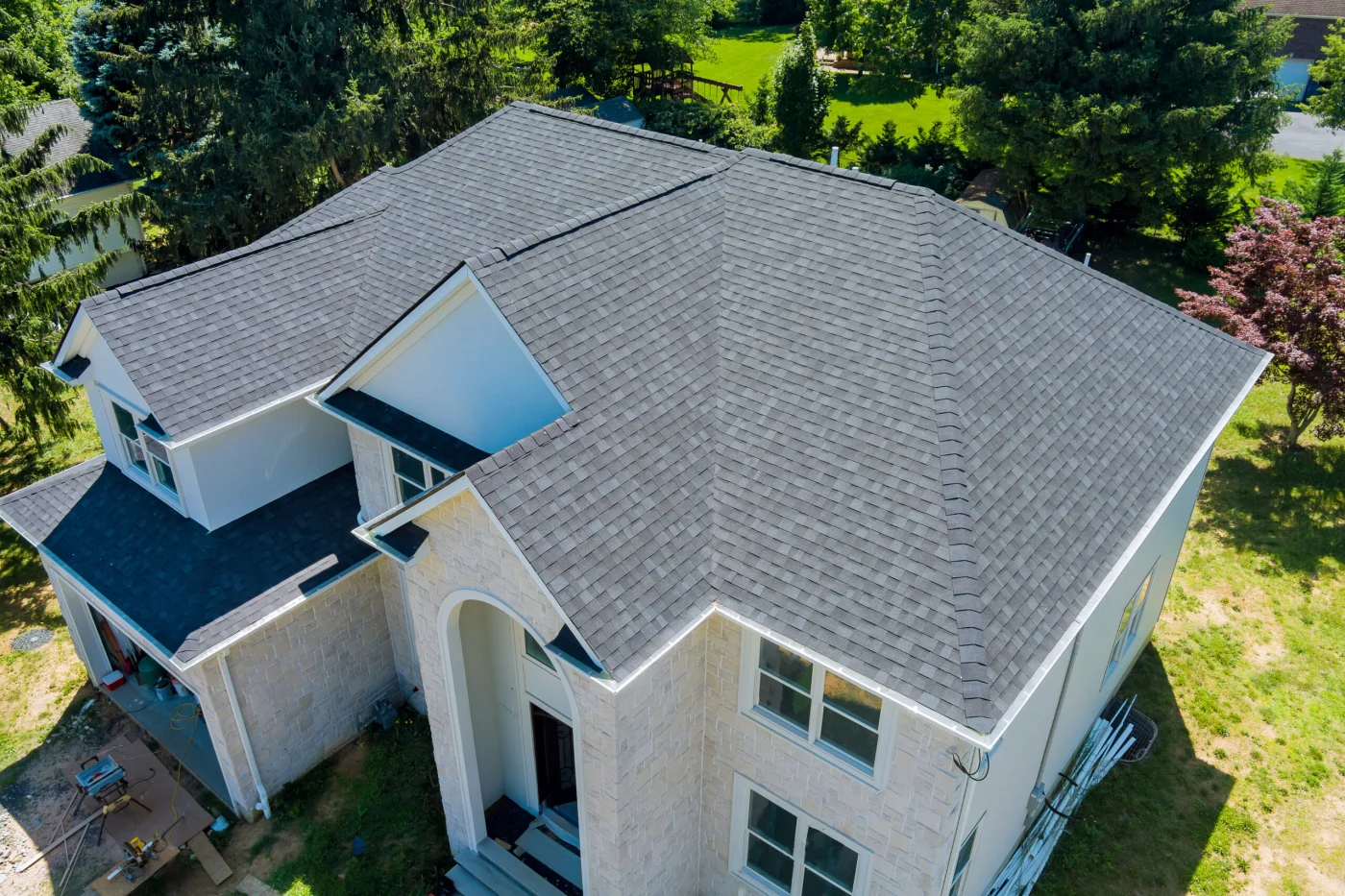 A large home with new gray asphalt shingle roofing