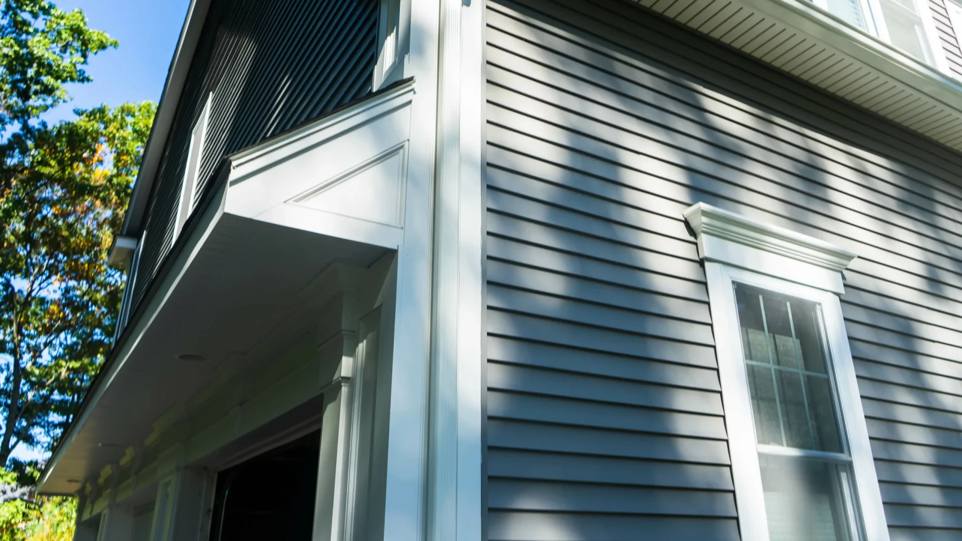 Pale blue siding on a house with a view from a corner outside in Marlton, NJ, by Ameritech Services.