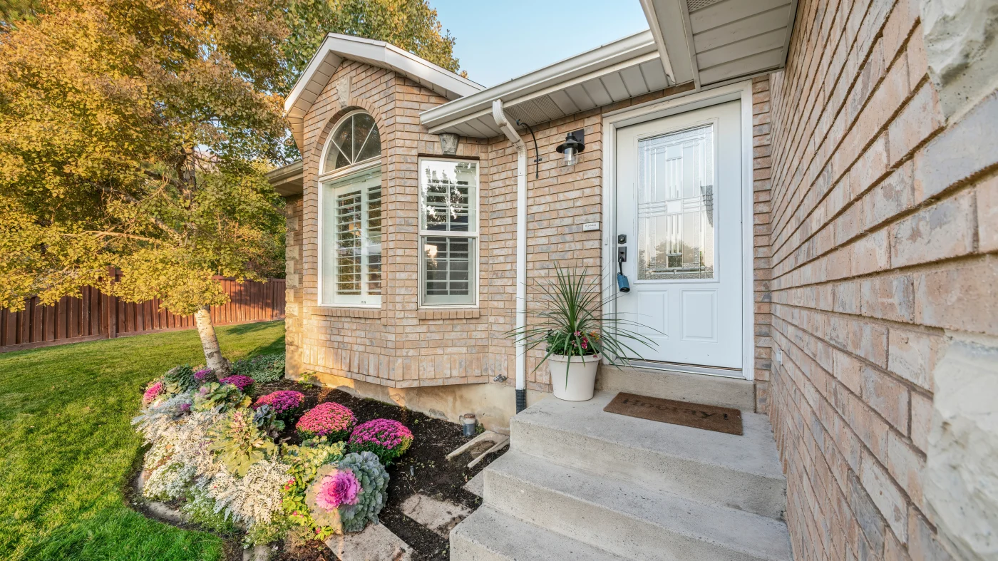 A white entry door in a brick home
