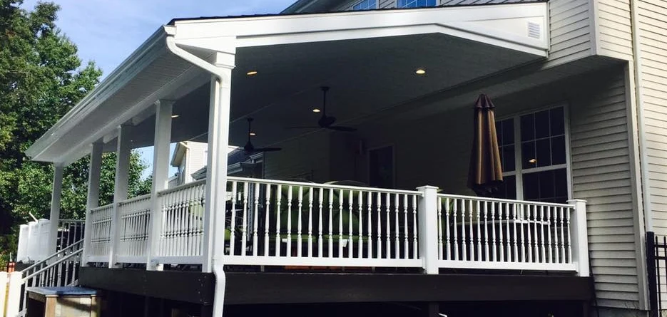 A deck with a white railing