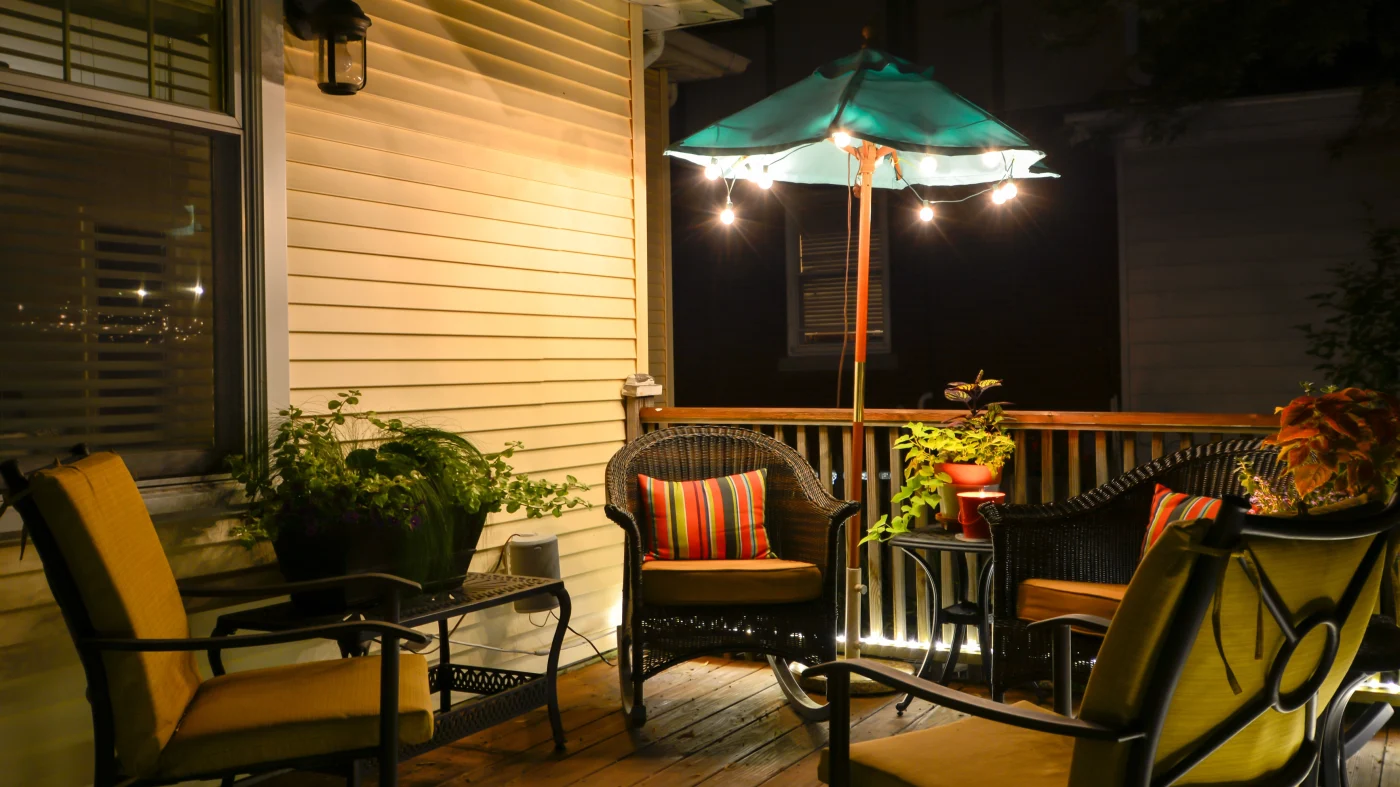 A deck at night with a seating area