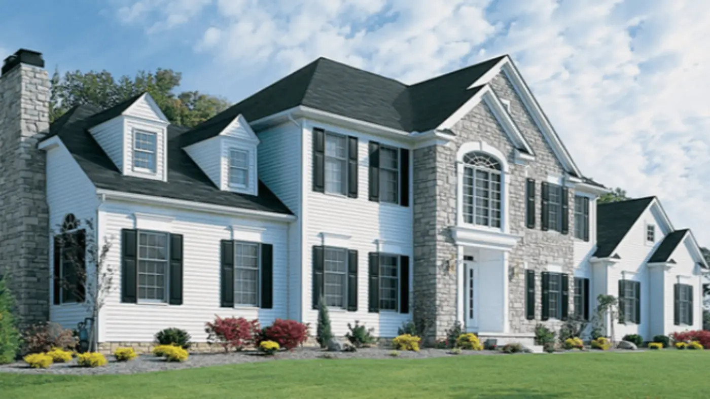 A large white house with stonework in the center and black shutters in Swedesboro, NJ, by Ameritech Services.
