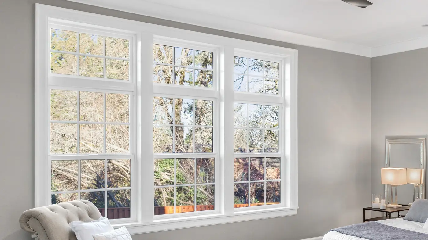 Three white trimmed windows from inside a bedroom in Swedesboro, NJ, by Ameritech Services.