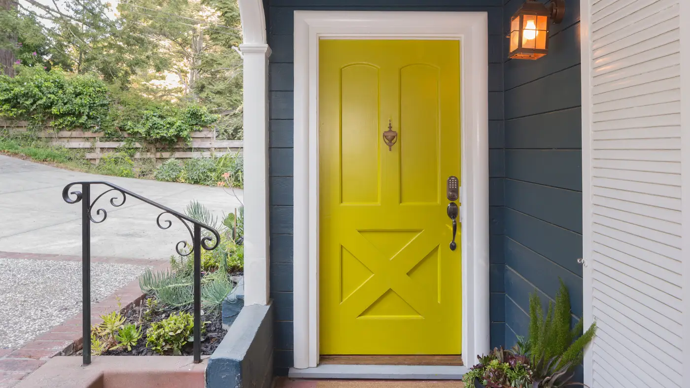 A close-up of a porch with a Yellow front entry door in Swedesboro, NJ, by Ameritech Services.