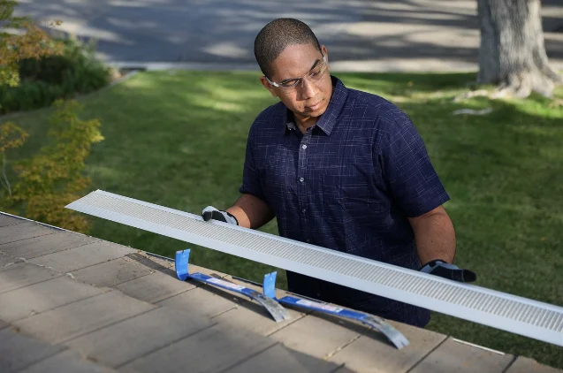 Ameritech professional installing gutter guards for a New Jersey home. 